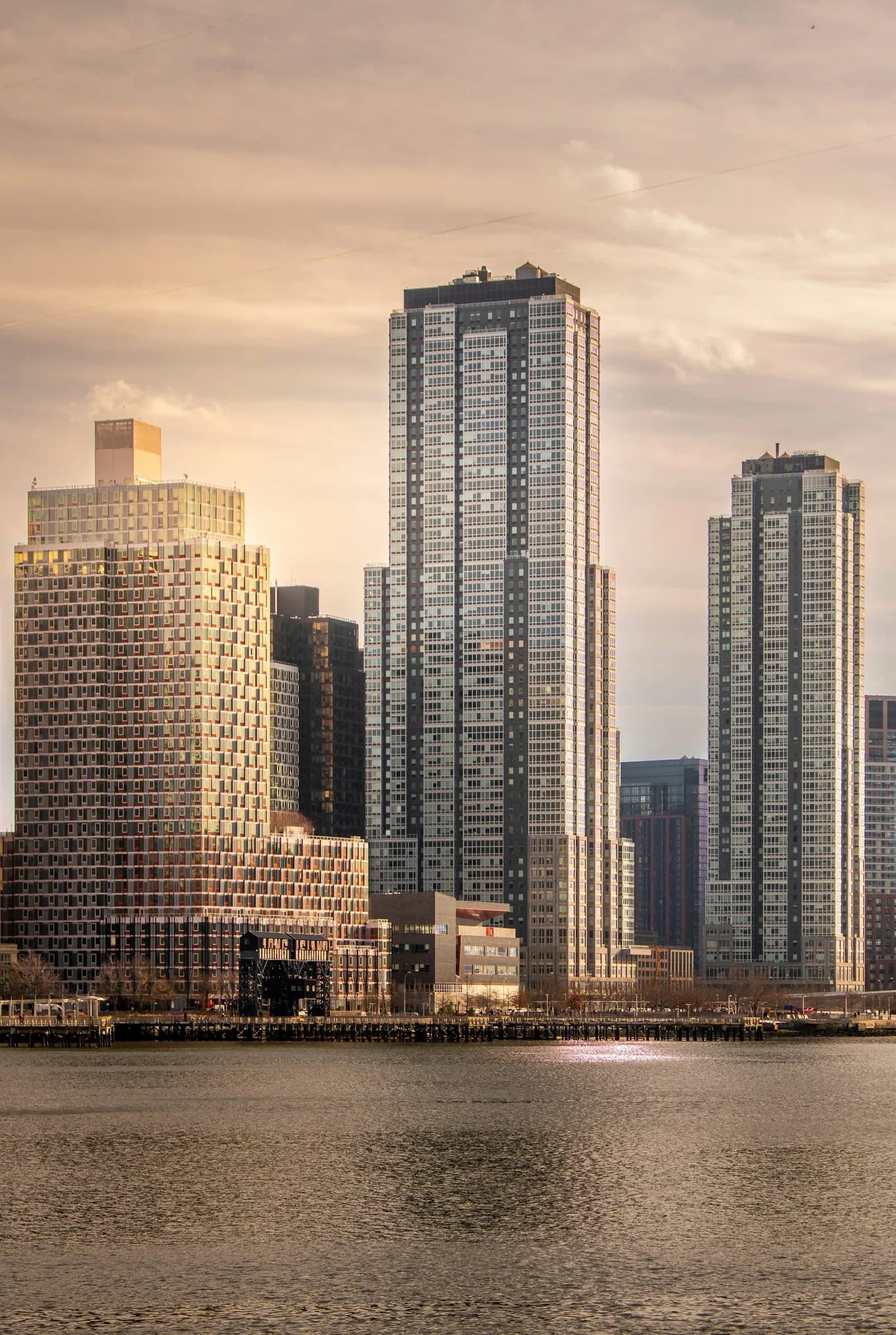Waterfront apartment towers at sunset.
